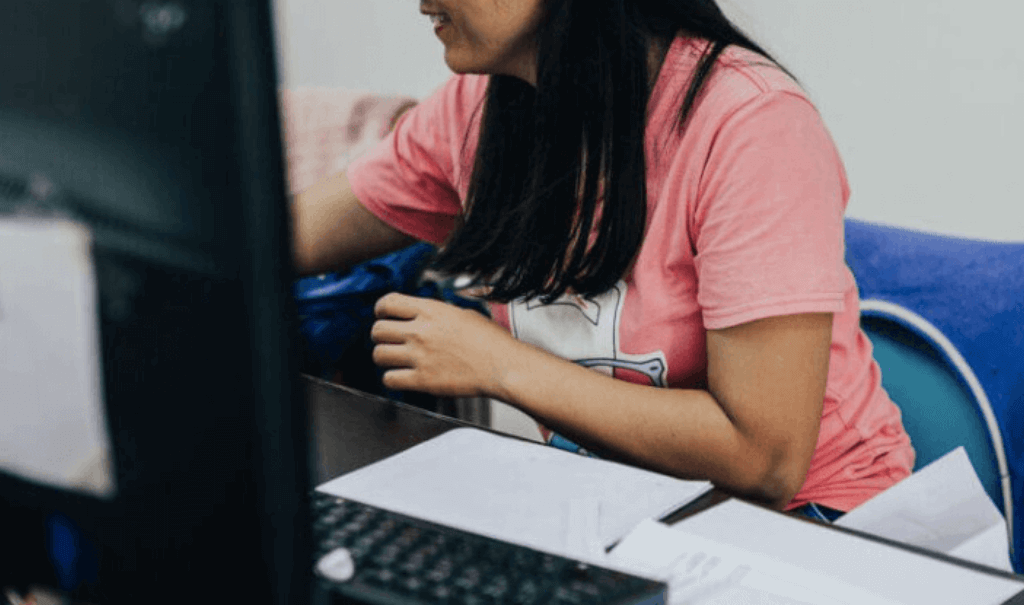 woman smiles and works on computer