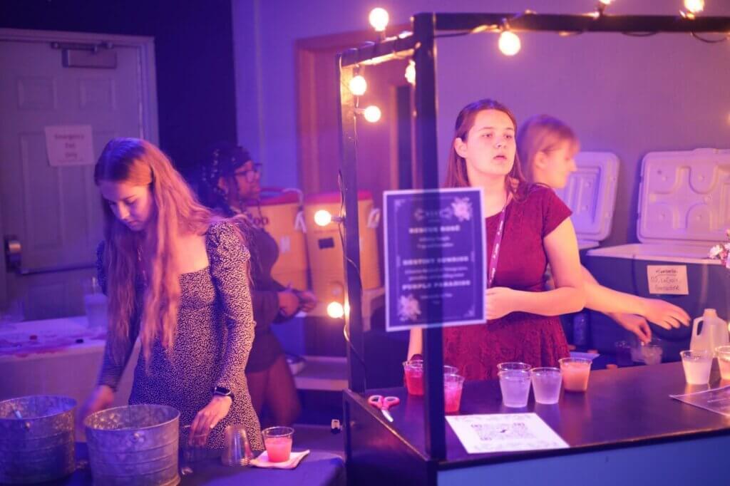 Students serving drinks